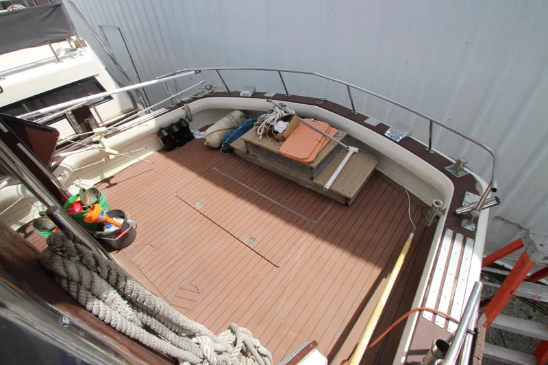 Slide: The Image of 1965 Chris-Craft Commander boat deck with wooden flooring and nautical equipment. - 7