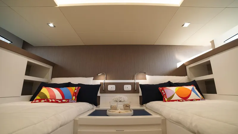 Slide: The Image of Modern cabin interior of 2025 Fiart 43 Seawalker yacht with twin beds and colorful pillows. - 13