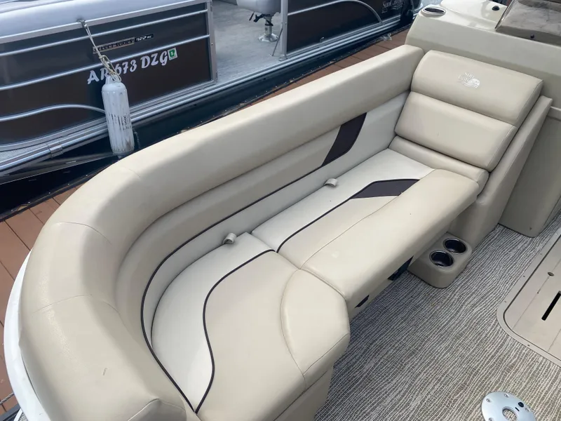 Slide: The Image of 2022 SunCatcher Select 322RC boat with beige leather seating and cup holders. - 5