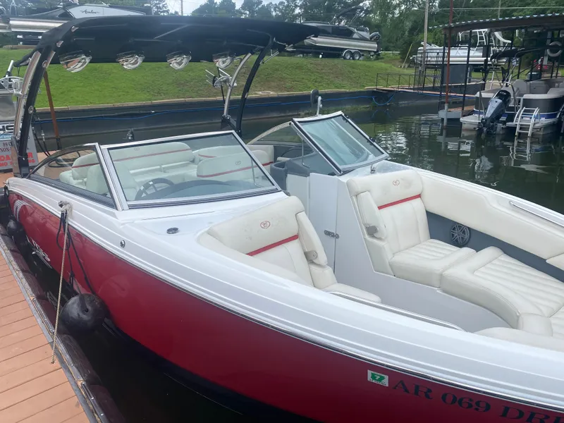 Slide: The Image of 2016 Cobalt R5 WSS boat docked, featuring red and white exterior with spacious seating. - 2