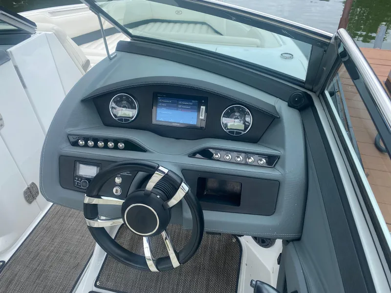 Slide: The Image of 2016 Cobalt R5 WSS boat dashboard with steering wheel and control panel. - 6