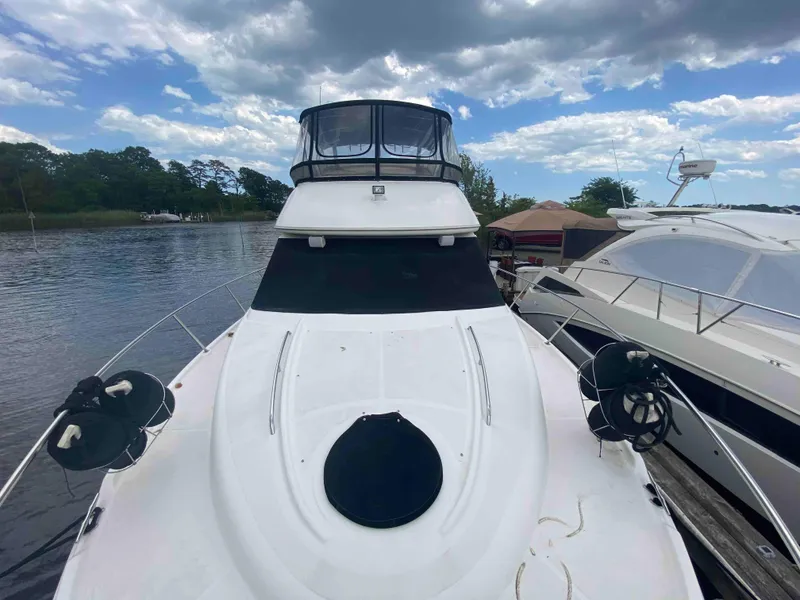 Slide: The Image of 2004 Meridian 381 Sedan yacht docked by the water. - 12