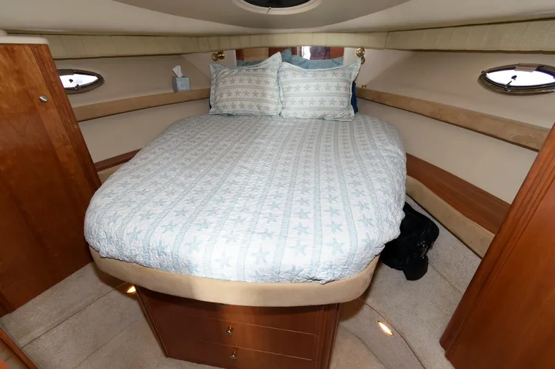 Slide: The Image of Luxurious bedroom in 2004 Meridian 381 Sedan yacht with cozy bed and elegant wood finishes. - 21