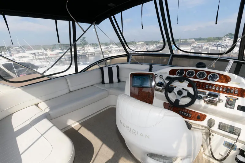 Slide: The Image of 2004 Meridian 381 Sedan yacht interior with helm and seating area. - 6