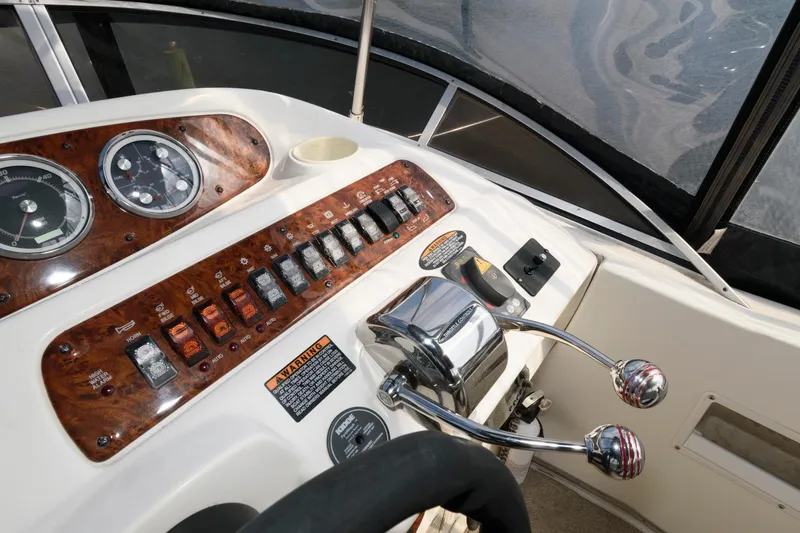 Slide: The Image of 2004 Meridian 381 Sedan boat control panel with gauges and throttle levers. - 9