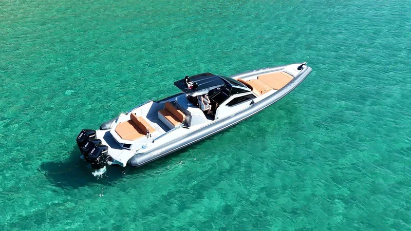 Slide: The Image of Luxury DNA 46 boat cruising on clear turquoise waters, 2025 model. - 0