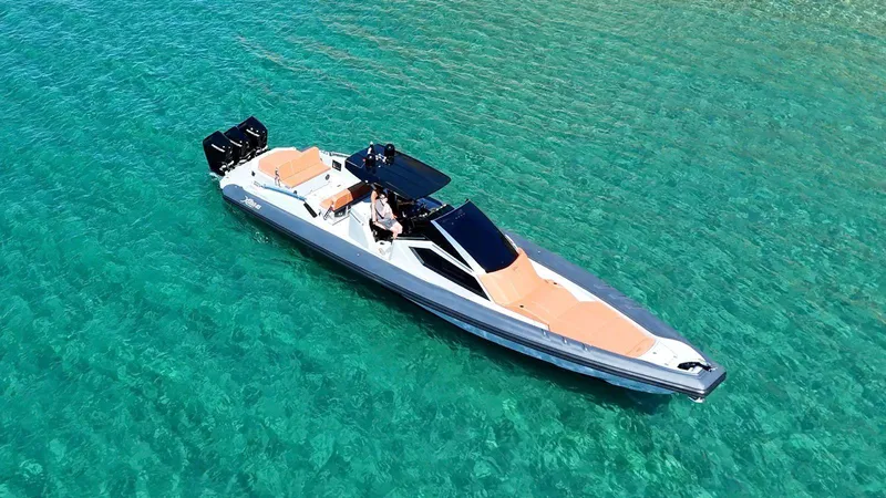 Slide: The Image of Aerial view of a 2025 DNA 46 boat on clear turquoise water. - 1