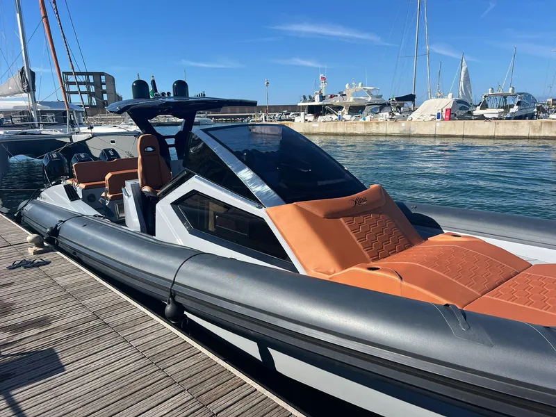 Slide: The Image of Luxury DNA 46 boat docked at marina, 2025 model, sleek design, and modern features. - 10