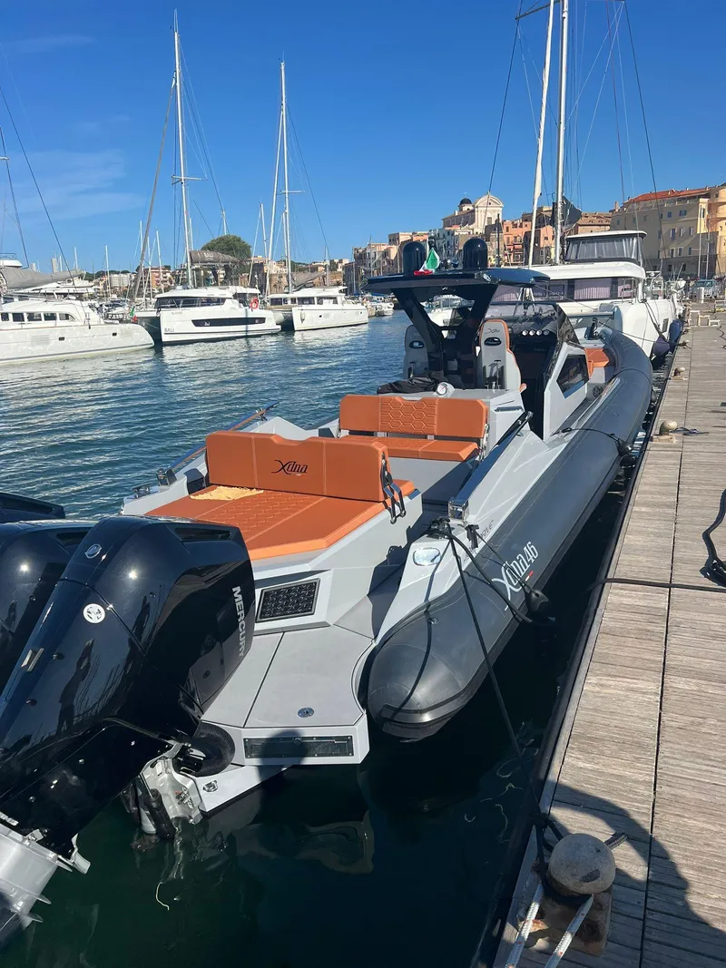 Slide: The Image of 2025 DNA 46 boat docked in a marina with other yachts. - 11