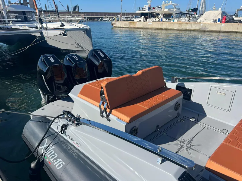 Slide: The Image of Modern DNA 46 boat with triple outboard engines docked at marina, 2025 model. - 13