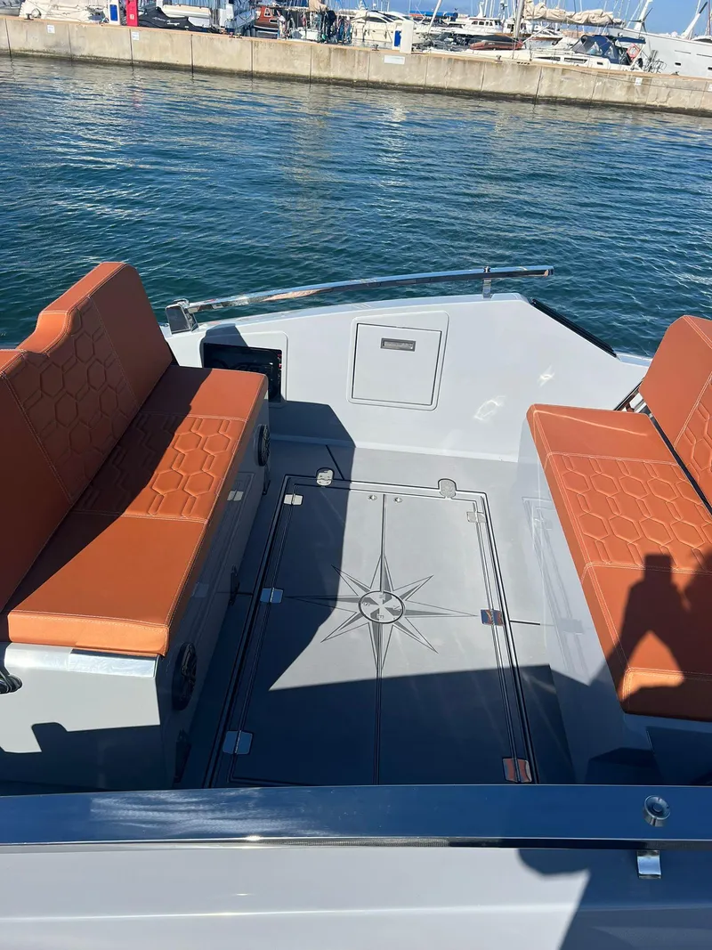 Slide: The Image of 2025 DNA 46 boat with orange seats docked at marina. - 16