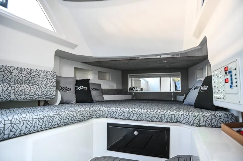 Slide: The Image of Modern DNA 46 boat interior, 2025 model, featuring a spacious cabin with patterned cushions and control panel. - 18
