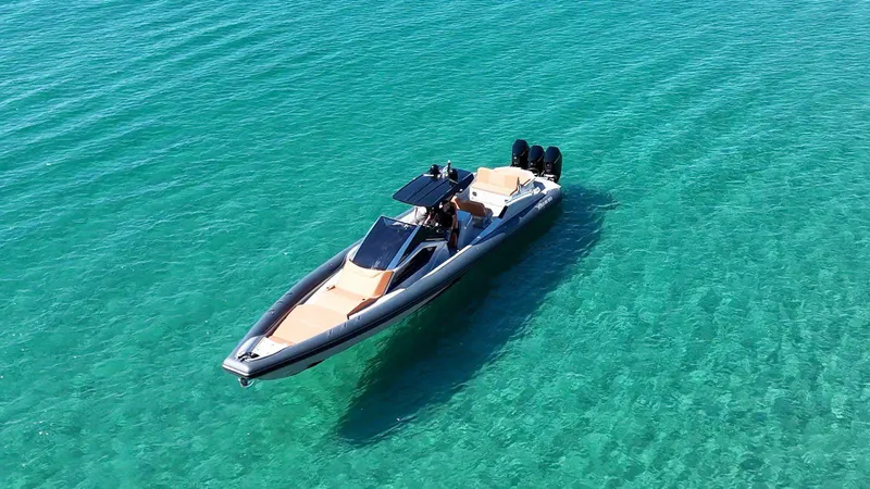 Slide: The Image of DNA 46 boat 2025 model cruising on clear turquoise water. - 2