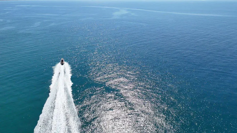 Slide: The Image of Aerial view of DNA 46 boat cruising on open ocean, 2025 model. - 23