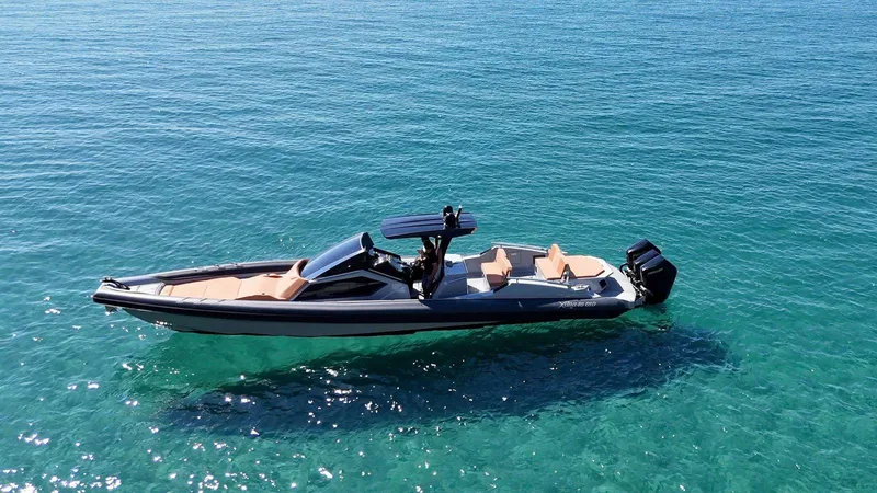 Slide: The Image of DNA 46 boat 2025 model cruising on clear blue water. - 4