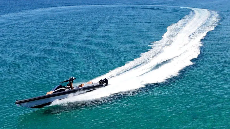 Slide: The Image of High-speed DNA 46 boat cruising on clear blue ocean waters, 2025 model. - 8