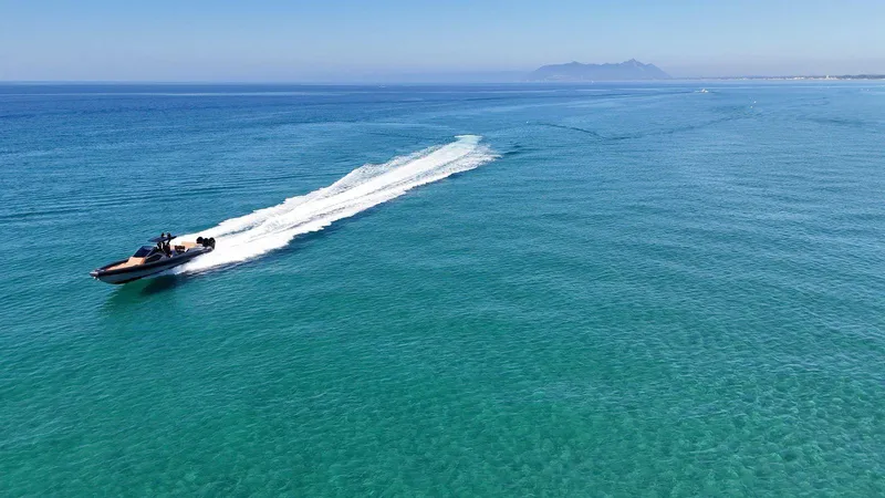 Slide: The Image of Speedboat DNA 46 (2025) cruising on clear blue ocean waters. - 9