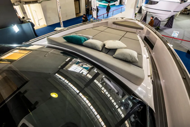 Slide: The Image of Nassima Yacht N40 2025 model with luxurious deck seating and cushions at a boat show. - 14