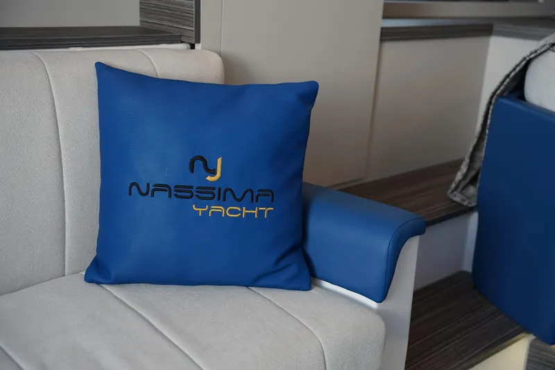 Slide: The Image of Blue Nassima Yacht N40 pillow on a white sofa, 2025 model interior. - 30