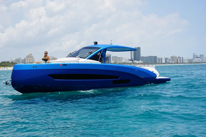 Slide: The Image of Nassima Yacht N40 2025 model cruising on clear blue waters near a city skyline. - 4