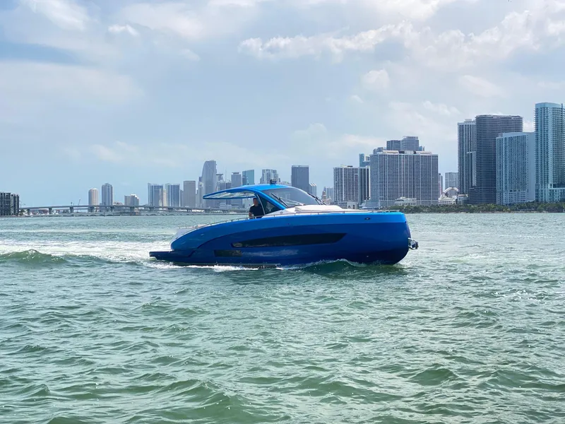 Slide: The Image of Blue Nassima Yacht N40 cruising near city skyline, 2025 model. - 6