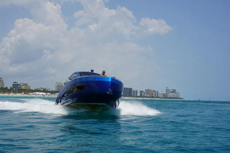 Slide: The Image of Nassima Yacht N40 2025 cruising on blue ocean near city skyline. - 7