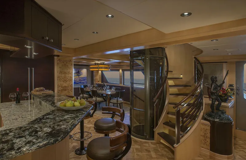 Slide: The Image of Luxurious interior of 2019 Nordlund Expedition Yachtfisher with modern kitchen, dining area, and spiral staircase. - 5