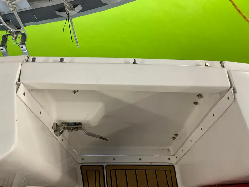 Slide: The Image of 2000 Mainship Pilot boat deck with storage compartment and vibrant green background. - 14