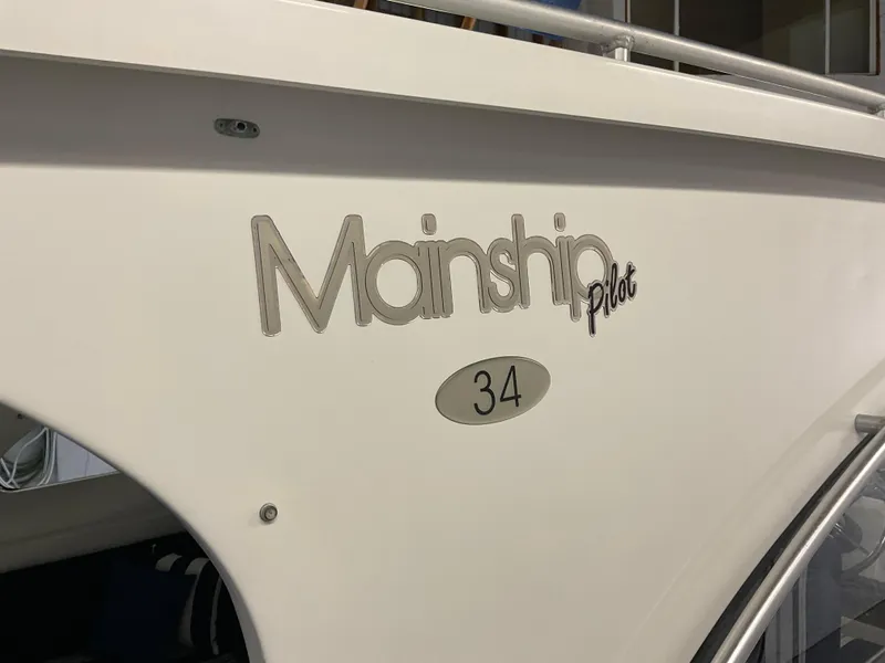 Slide: The Image of 2000 Mainship Pilot 34 boat side view with logo and model number. - 25