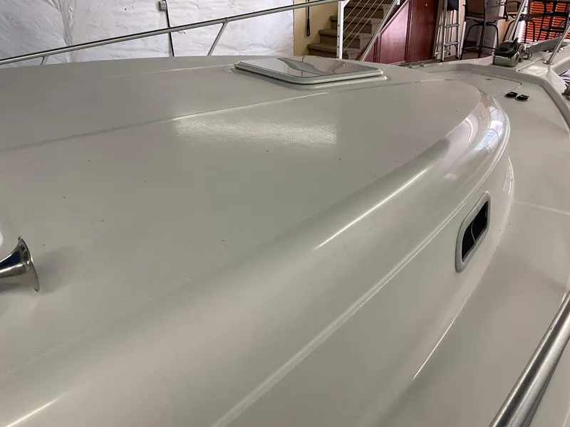 Slide: The Image of 2000 Mainship Pilot boat deck with railing and hatch, indoors. - 26