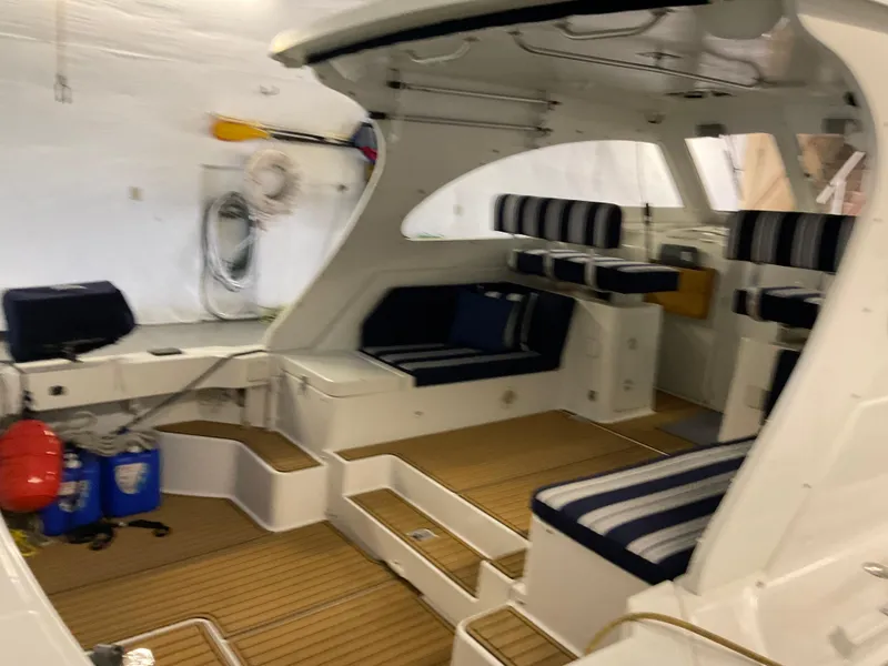 Slide: The Image of Interior of 2000 Mainship Pilot boat with striped seating and wooden flooring. - 4