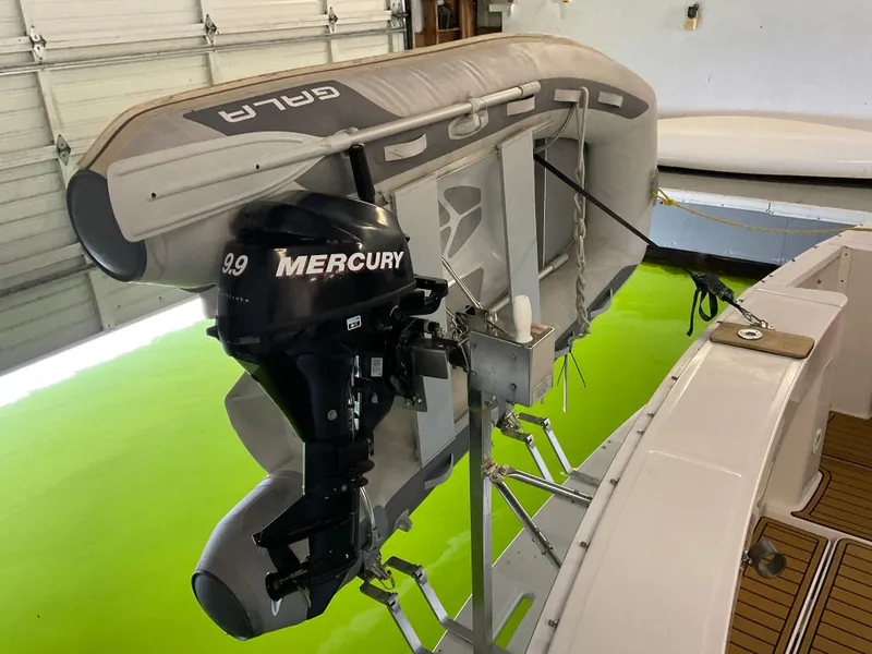 Slide: The Image of 2000 Mainship Pilot with Mercury outboard motor and inflatable boat in a garage. - 5