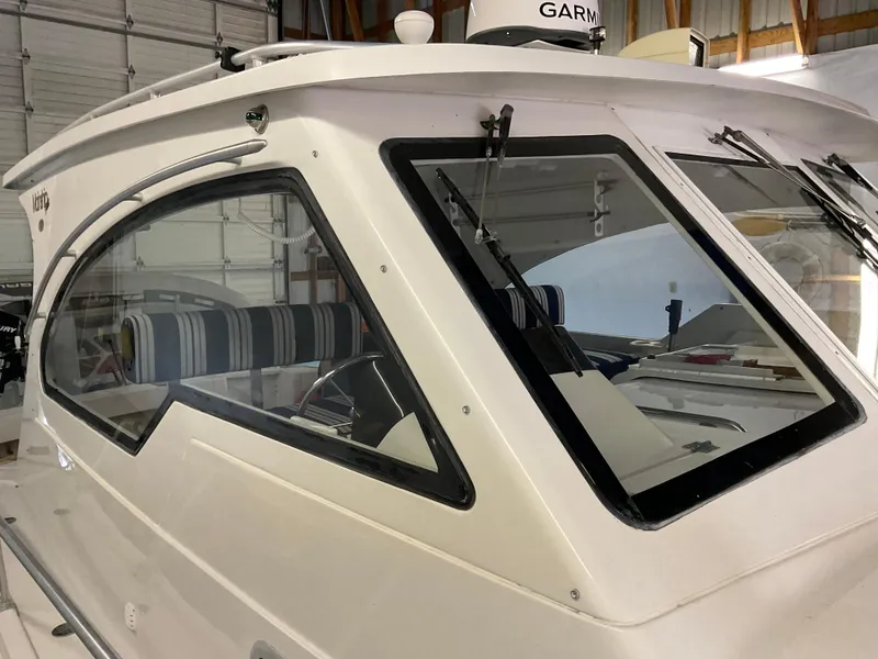 Slide: The Image of 2000 Mainship Pilot boat cabin with striped interior, docked indoors. - 6