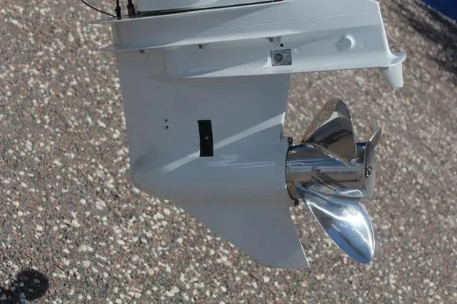 Slide: The Image of 2021 Blue Wave 2000 Pure Bay boat propeller, shiny metal finish, on gravel background. - 12