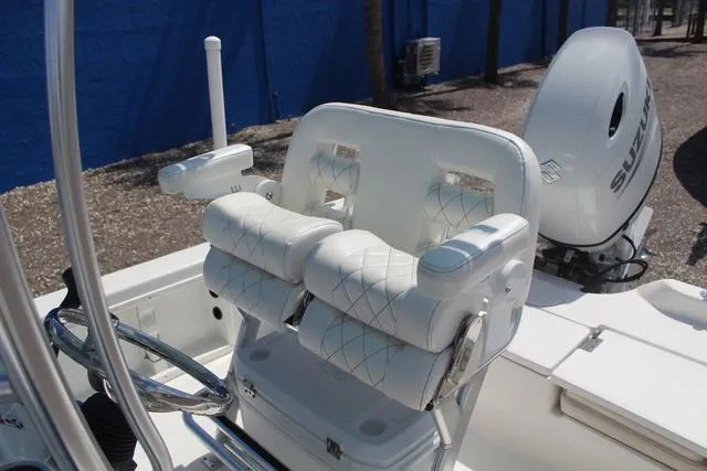 Slide: The Image of 2021 Blue Wave 2000 Pure Bay boat with white cushioned seating and Suzuki outboard motor. - 18