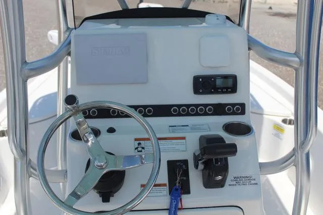 Slide: The Image of 2021 Blue Wave 2000 Pure Bay boat console with steering wheel and controls. - 19