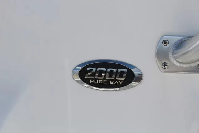 Slide: The Image of 2021 Blue Wave 2000 Pure Bay boat emblem on white surface. - 9
