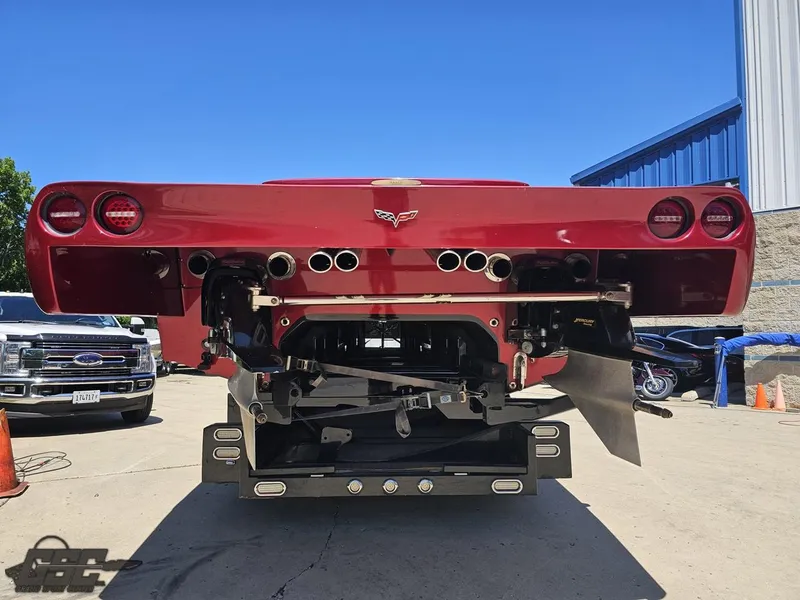 Slide: The Image of Red 2010 MTI 44 Corvette boat on trailer, side view under clear blue sky. - 15