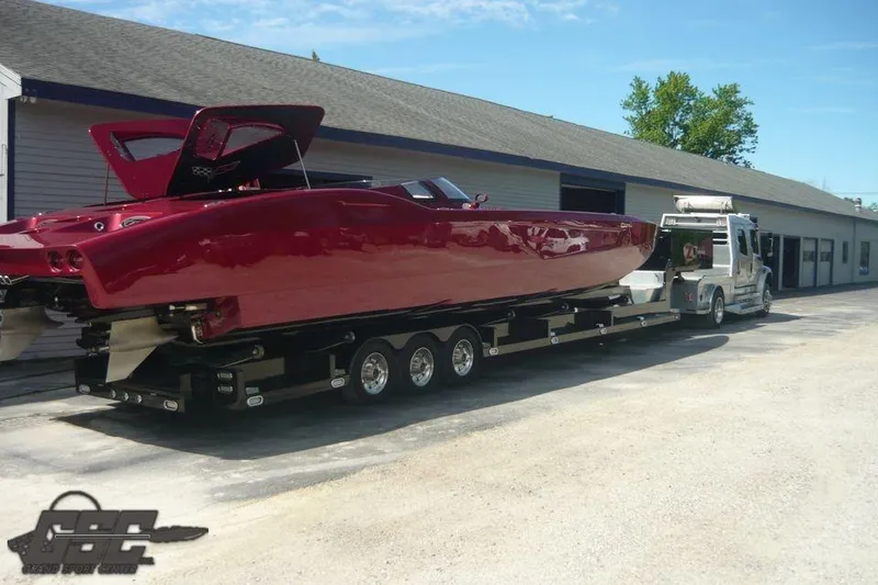 Slide: The Image of Red 2010 MTI 44 Corvette boat on trailer, showcasing sleek design and rear view. - 20