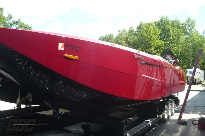 Slide: The Image of Red 2010 MTI 44 Corvette with black racing stripe and emblem on hood. - 21