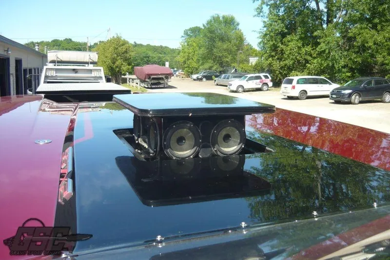 Slide: The Image of Red 2010 MTI 44 Corvette boat on trailer, parked outdoors under clear sky. - 27