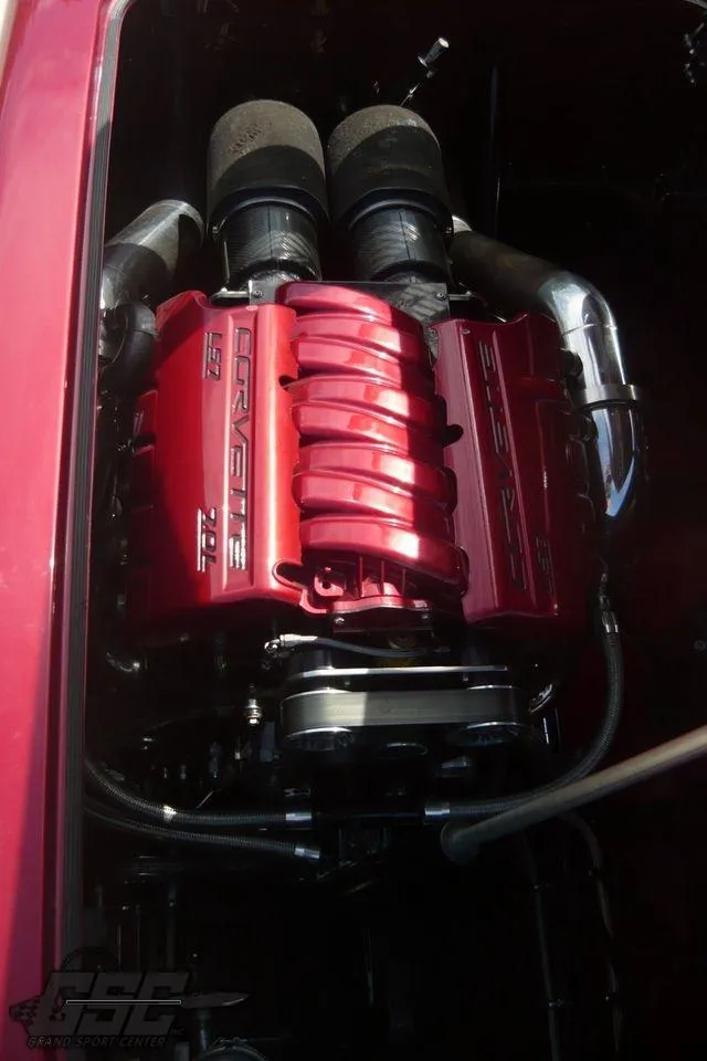 Slide: The Image of 2010 MTI 44 Corvette powerboat on trailer, glossy red finish, sunny day. - 30