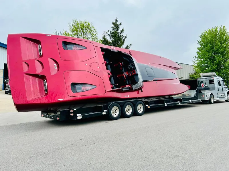 Slide: The Image of Red 2010 MTI 44 Corvette hood with visible engine components. - 37