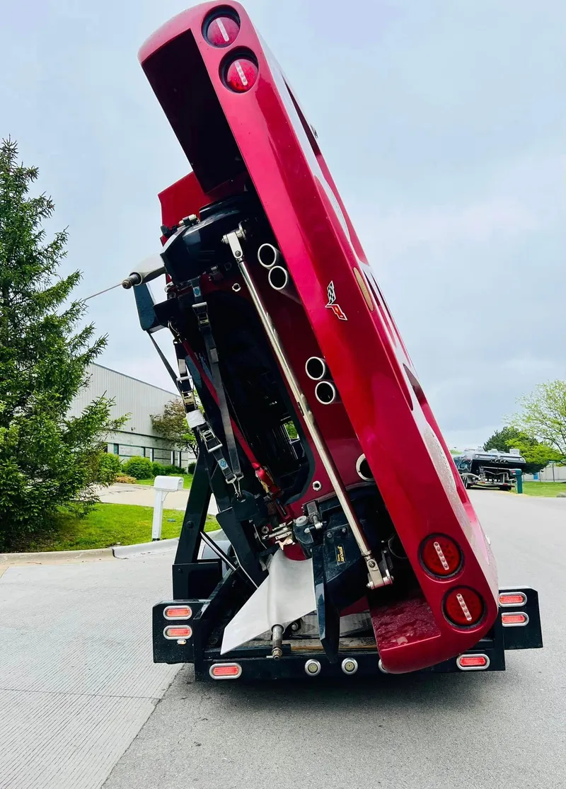 Slide: The Image of Interior of a 2010 MTI 44 Corvette speedboat, featuring sleek red and black design. - 39