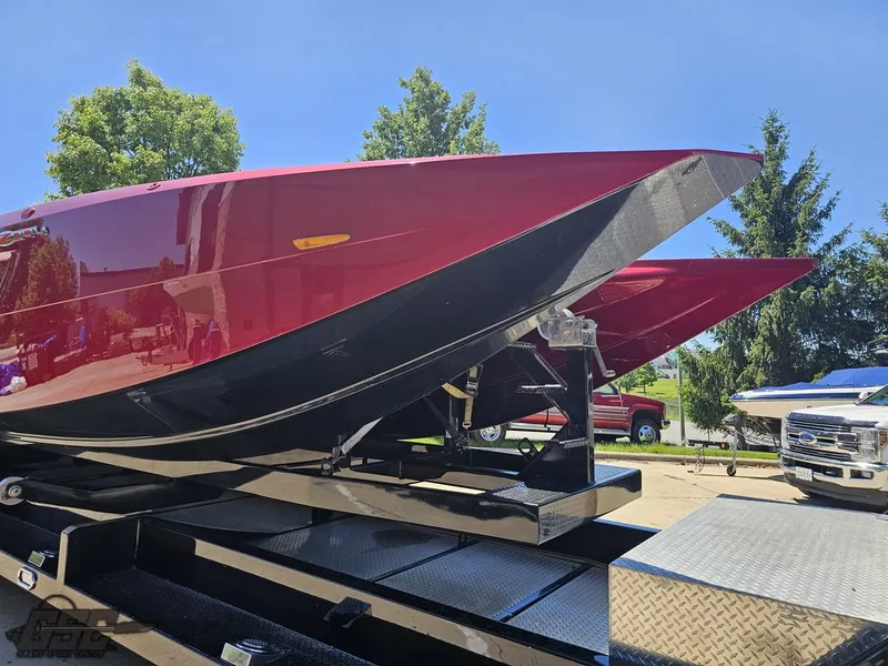 Slide: The Image of Red 2010 MTI 44 Corvette speedboat on trailer, showcasing sleek design and seating. - 4