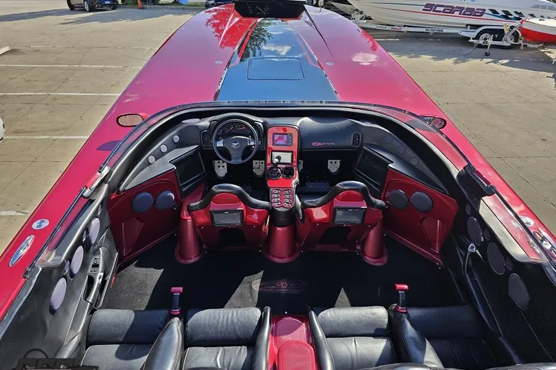 Slide: The Image of Interior of a 2010 MTI 44 Corvette speedboat, featuring a sleek red and black design. - 43