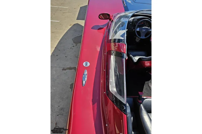 Slide: The Image of 2010 MTI 44 Corvette, red exterior, detailed cockpit view, parked on concrete surface. - 45