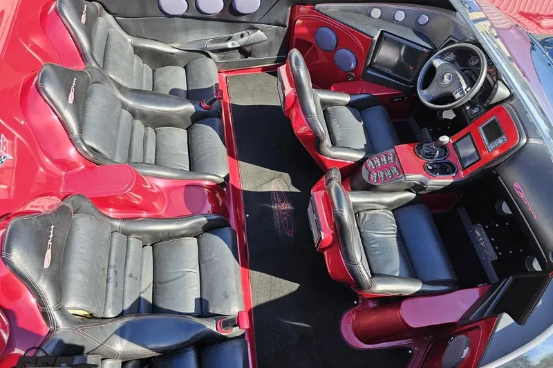 Slide: The Image of 2010 MTI 44 Corvette interior with red and black leather seats, modern dashboard. - 47