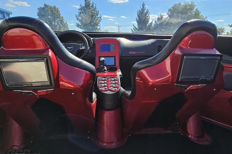 Slide: The Image of Interior of a customized 2010 MTI 44 Corvette with red and black design elements. - 48