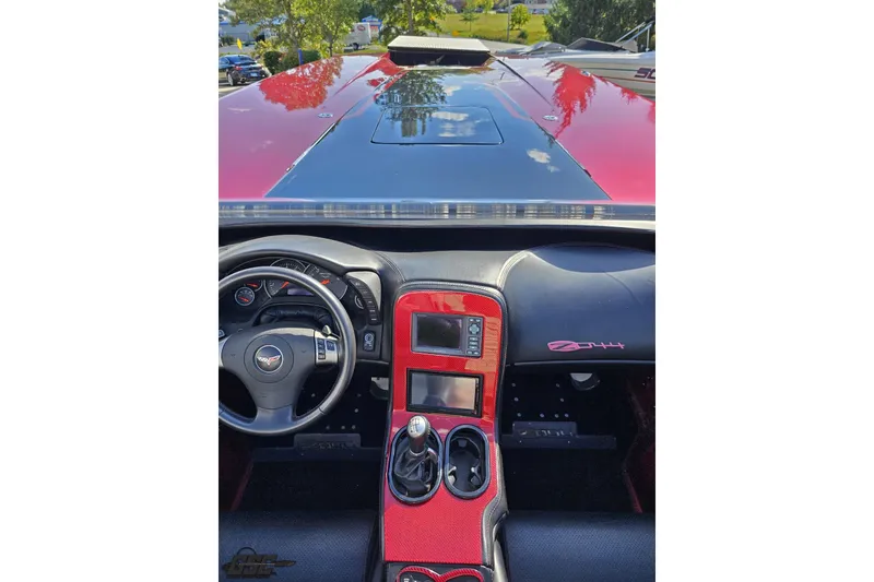 Slide: The Image of Interior view of a 2010 MTI 44 Corvette, featuring a sleek dashboard and steering wheel. - 49